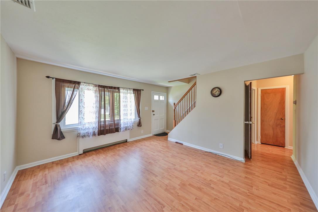 3050 Cornwall Road Bethlehem, PA 18017 - Photo 7 of 80 Warm wood flooring extends throughout this naturally illuminated living space, featuring an inviting entryway and staircase.