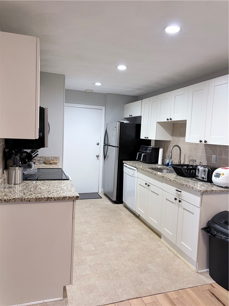 300 Smithfield Road, Unit P24 North Providence, RI 02904 - Photo 7 of 12 Hardwood cabinets, quartz countertop, plaster ceiling, stainless steel refrigerator, microwave, and stove.