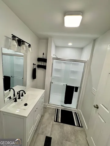a white bath tub sitting next to a white sink and vanity