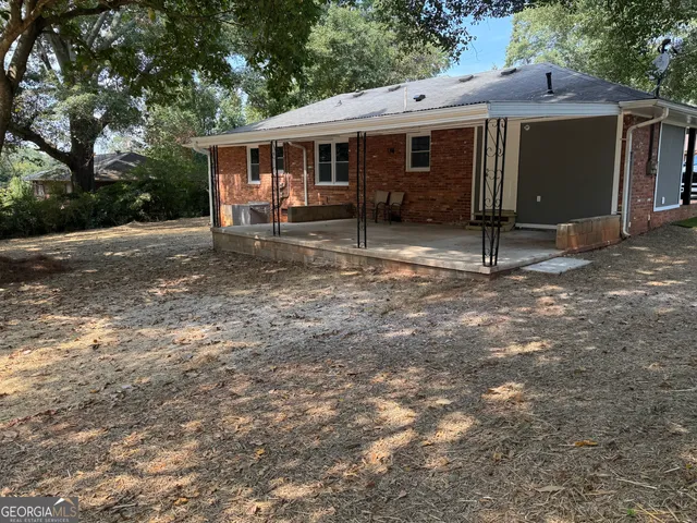 a backyard of a house with barbeque oven