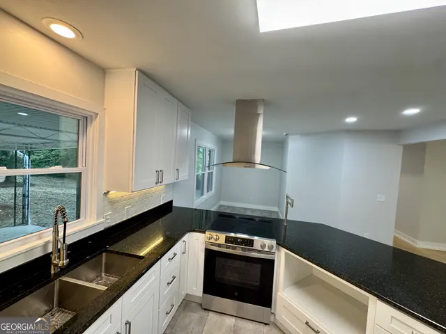 a kitchen with a sink and cabinets