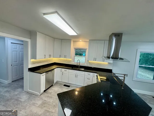 a kitchen with granite countertop a sink and appliances