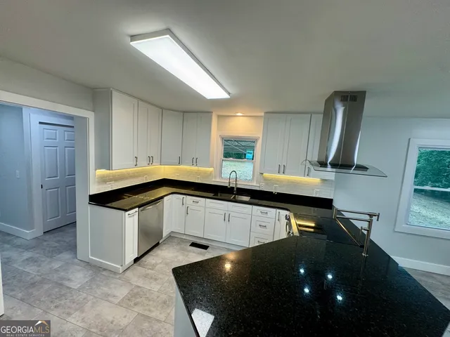 a kitchen with stainless steel appliances a sink a stove and a refrigerator