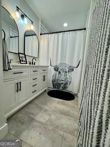 a bathroom with a double vanity sink and a mirror