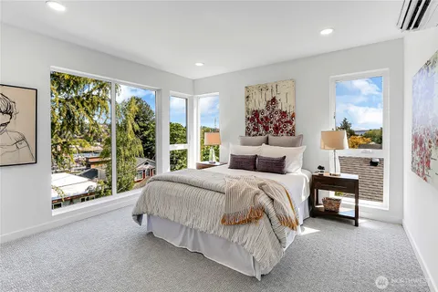 a spacious bedroom with a bed and a large window