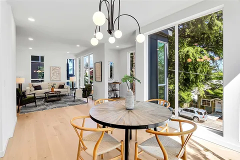 a view of a dining room with furniture and a potted plant