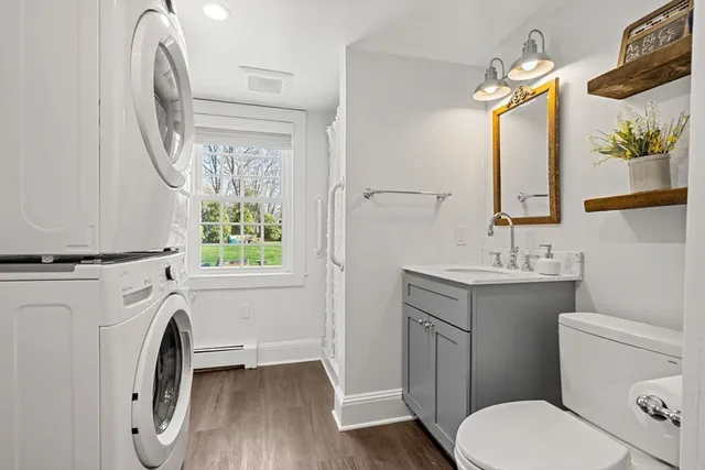a bathroom with a toilet a sink and a mirror