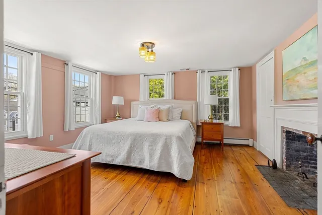 a bedroom with a bed and a fireplace