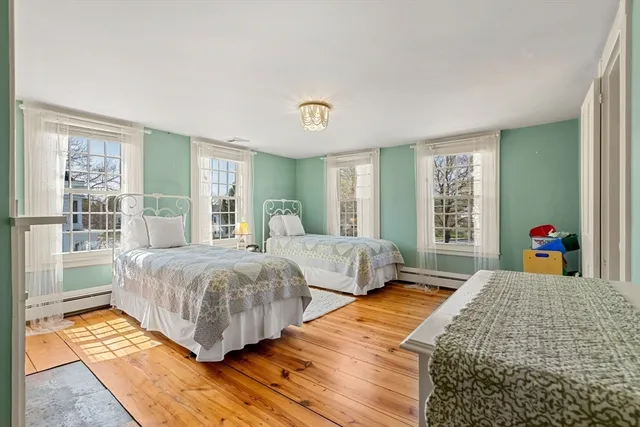 a bedroom with double bed and a large window