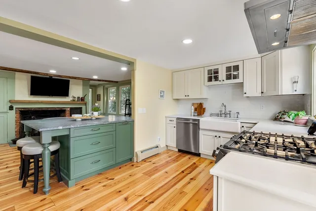 a kitchen with a sink and wooden floor