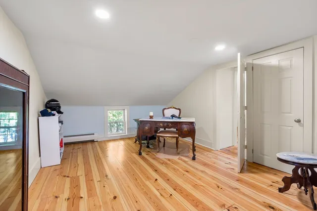 a view of a livingroom with furniture wooden floor and a window