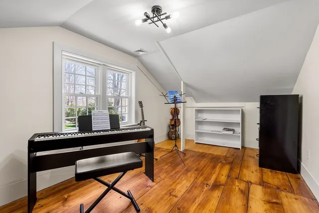 a livingroom with furniture and a piano