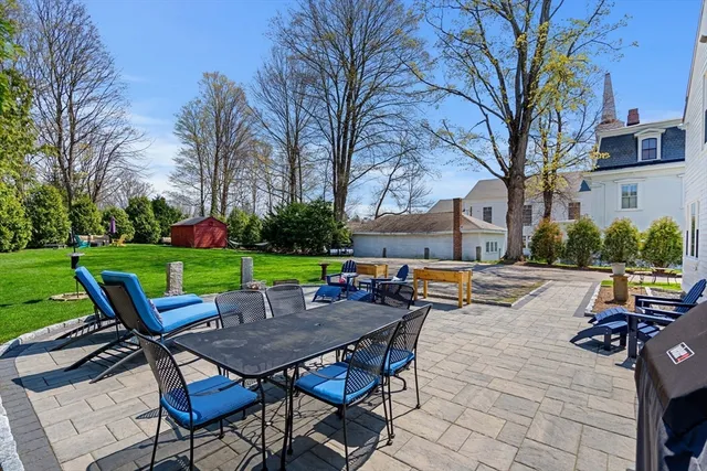 a view of a chairs and table in backyard of the house