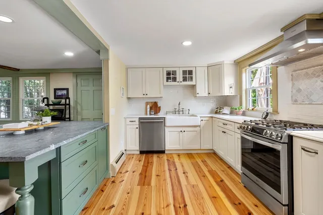a kitchen with a sink stove and cabinets