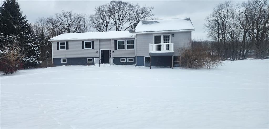 a view of a house with a yard covered in snow