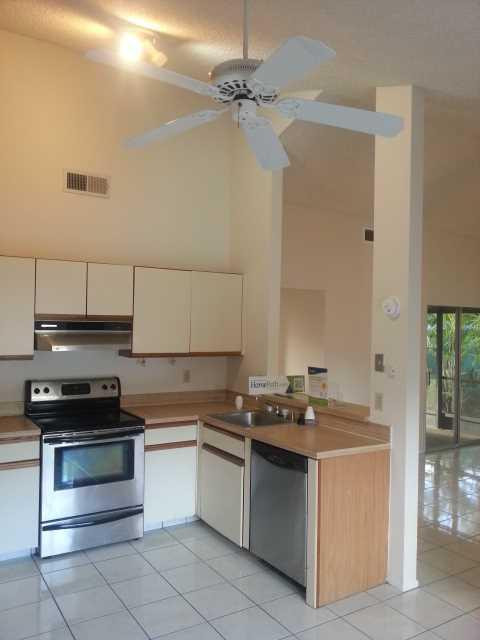 23279 New Coach Way Boca Raton, FL 33433 - Photo 5 of 16 a kitchen with stainless steel appliances granite countertop a sink stove and cabinets