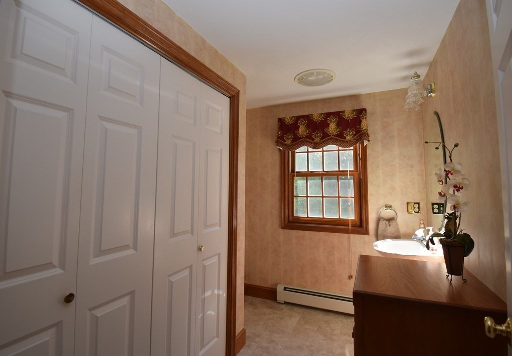 27 Exeter Road Kingston, NH 03848 - Photo 13 of 37 a bathroom with a sink and a mirror