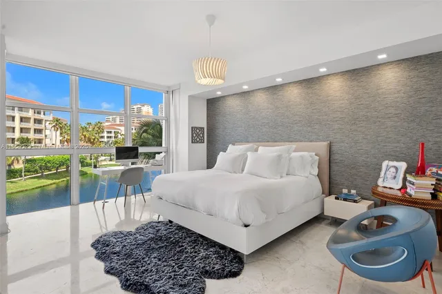 a living room with furniture and a floor to ceiling window