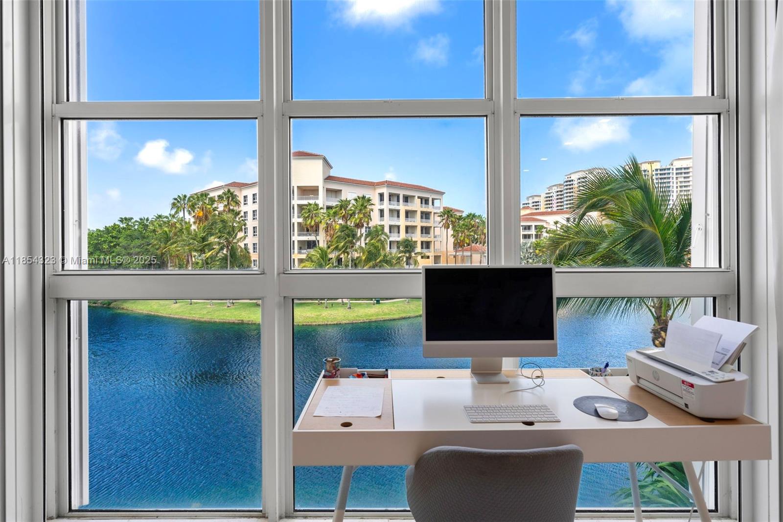 723 Crandon Boulevard, Unit 305 Key Biscayne, FL 33149 - Photo 13 of 29 a desktop computer sitting on top of a desk next to a window