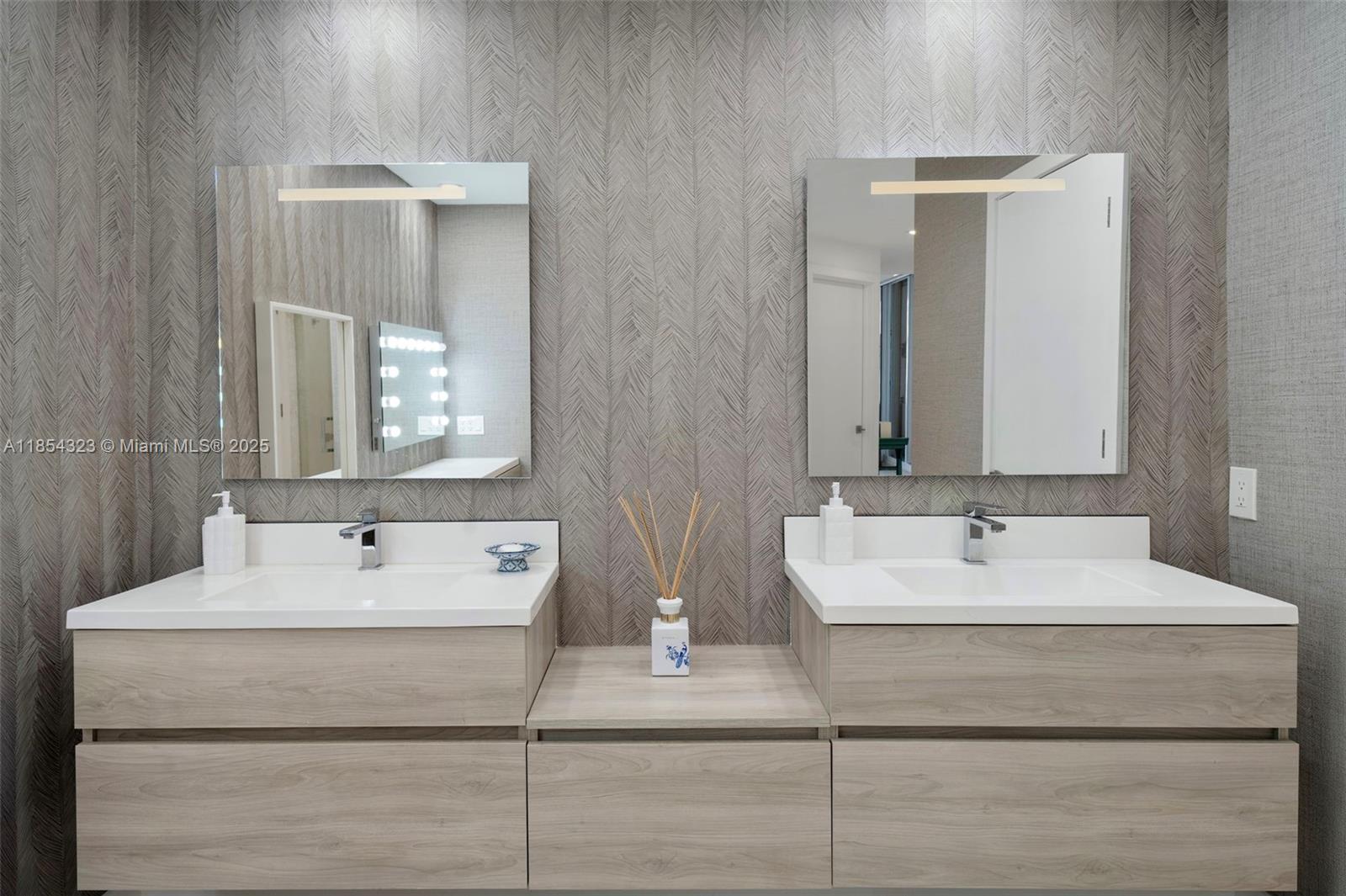 723 Crandon Boulevard, Unit 305 Key Biscayne, FL 33149 - Photo 16 of 29 a bathroom with a sink and a mirror