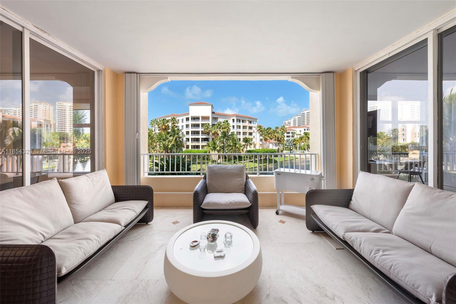 723 Crandon Boulevard, Unit 305 Key Biscayne, FL 33149 - Photo 19 of 29 a living room with furniture and a large window