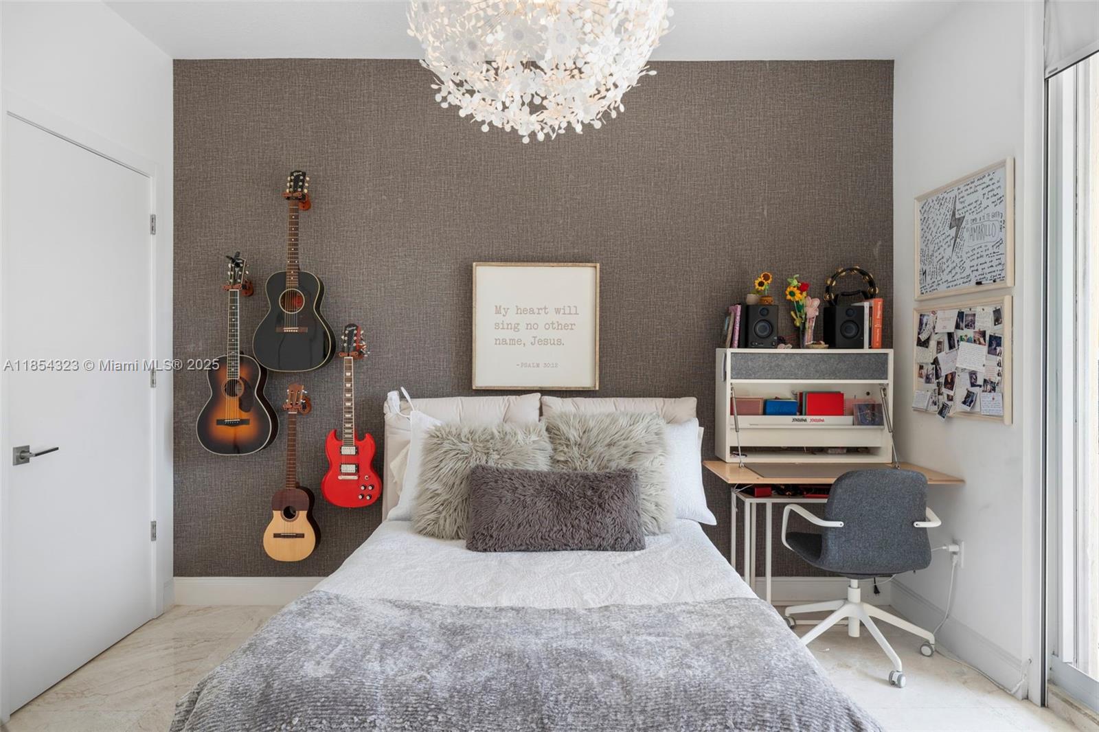 723 Crandon Boulevard, Unit 305 Key Biscayne, FL 33149 - Photo 21 of 29 a view of a hallway with paintings on the wall and a window
