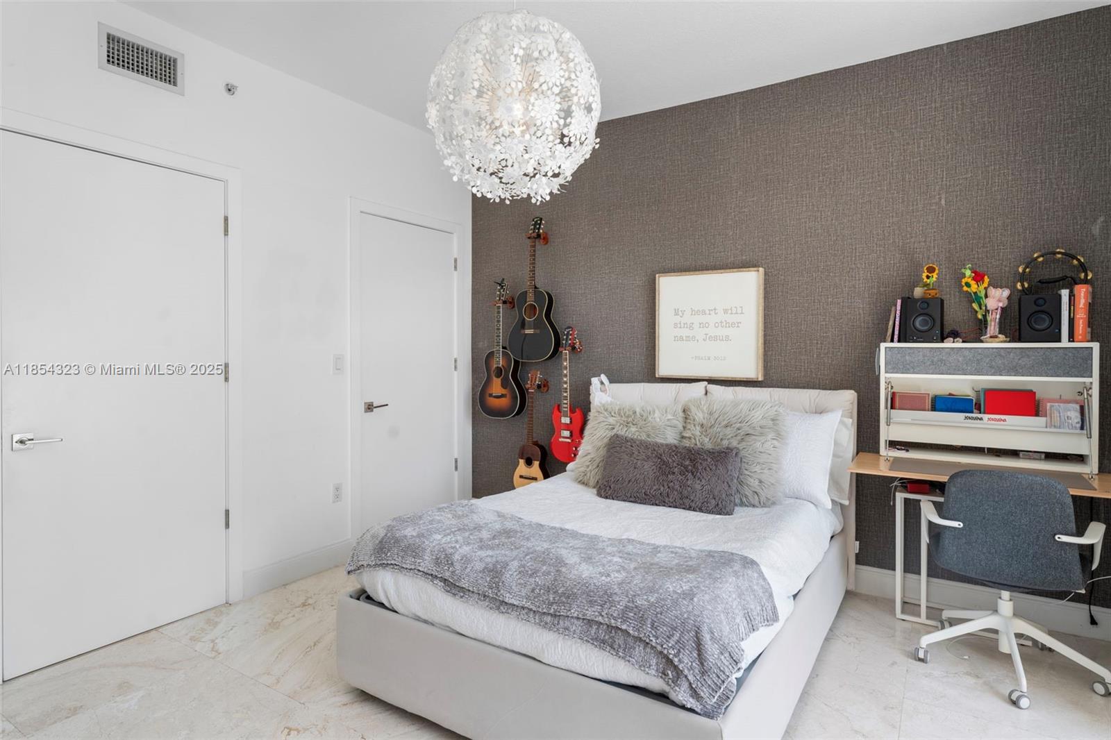 723 Crandon Boulevard, Unit 305 Key Biscayne, FL 33149 - Photo 22 of 29 a bedroom with a bed and a chandelier