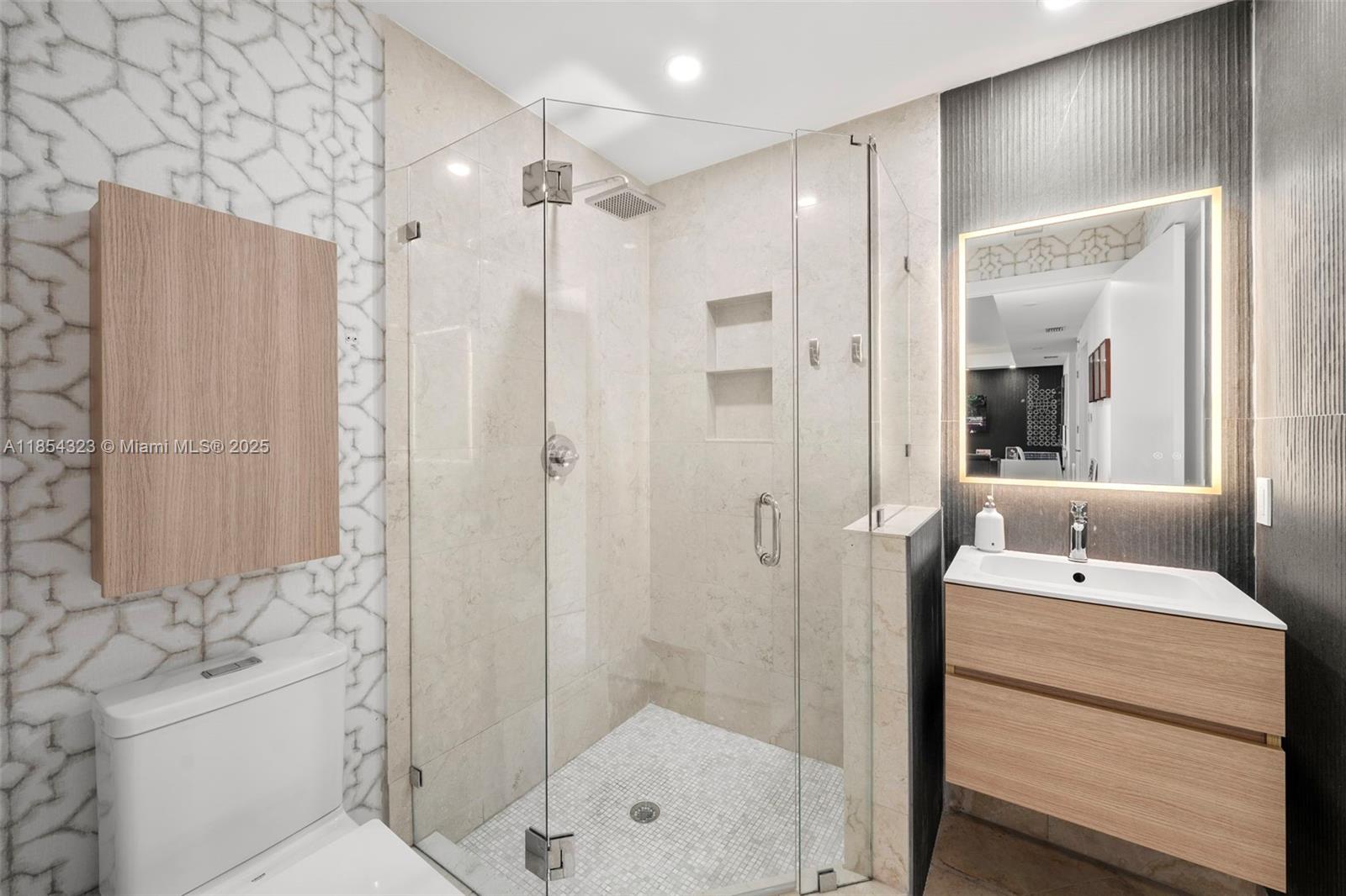 723 Crandon Boulevard, Unit 305 Key Biscayne, FL 33149 - Photo 27 of 29 a bathroom with a sink a toilet and shower