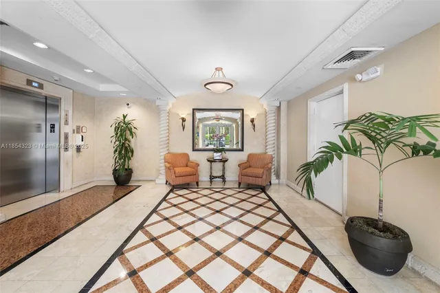 a living room with furniture lamp and a potted plant