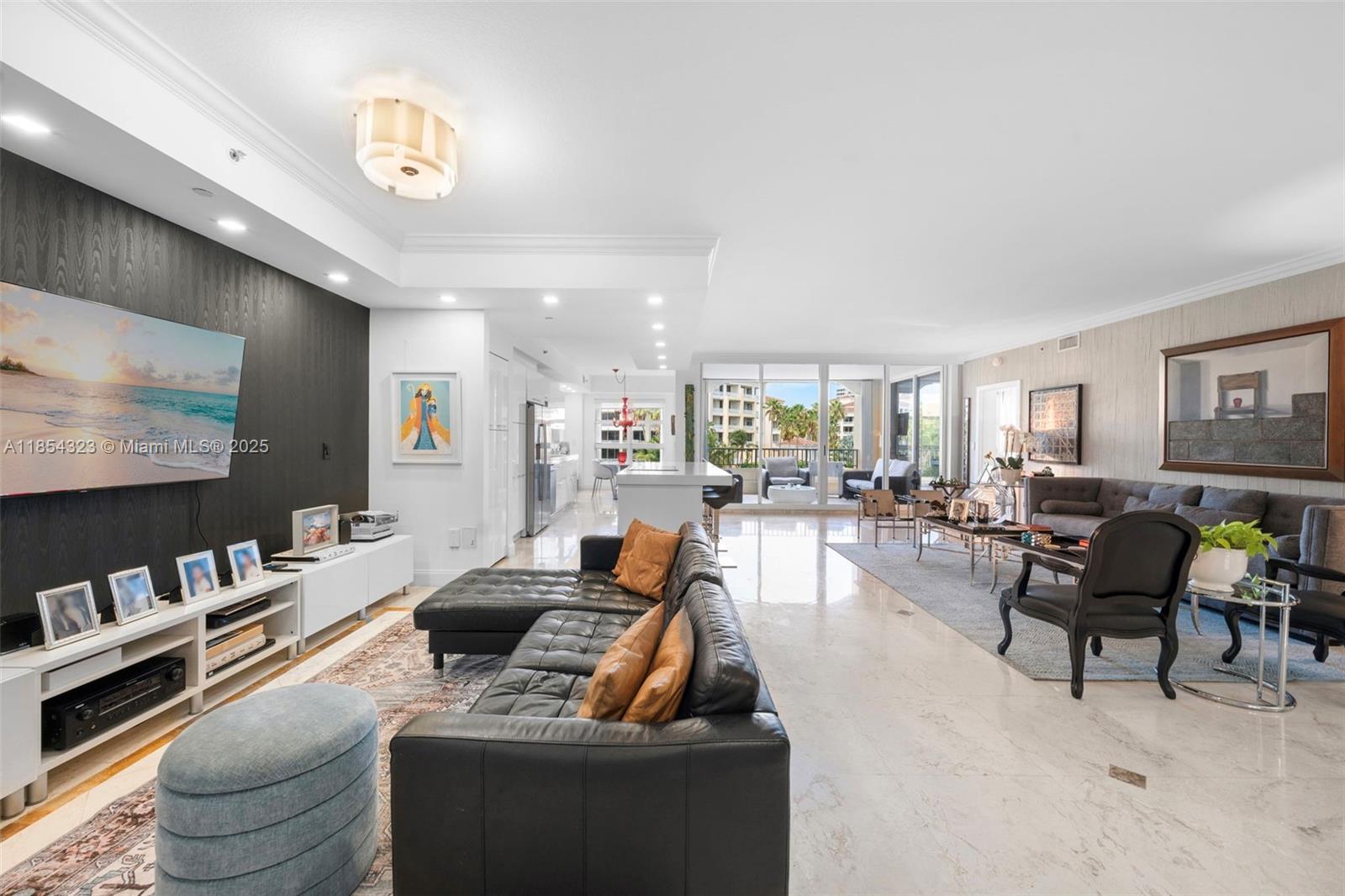 723 Crandon Boulevard, Unit 305 Key Biscayne, FL 33149 - Photo 5 of 29 a living room with furniture and a flat screen tv