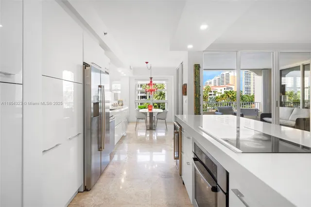 a kitchen with stainless steel appliances granite countertop a refrigerator and a sink