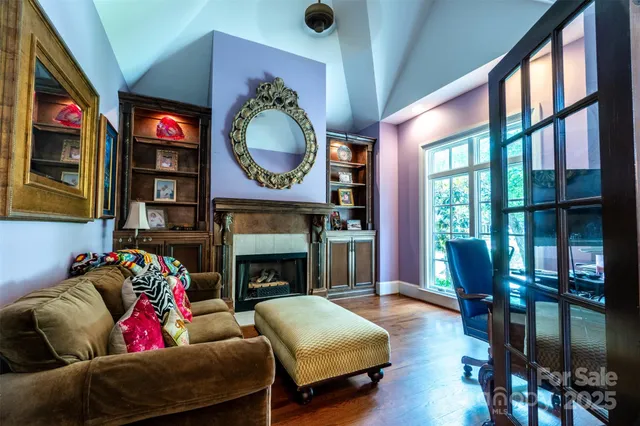 a living room with furniture fireplace and flat screen tv