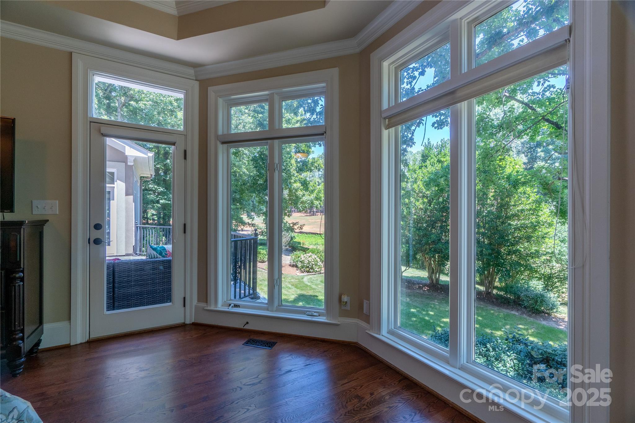 19002 Meta Road Cornelius, NC 28031 - Photo 21 of 48 a view of an empty room with wooden floor and a floor to ceiling window