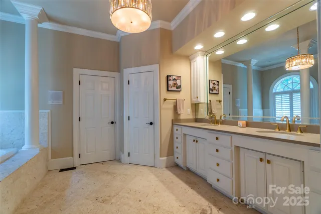 a bathroom with a granite countertop sink a light fixture and a mirror