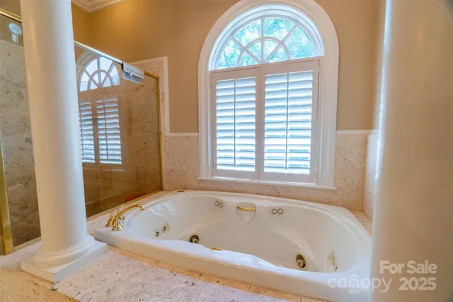 a bathroom with a bathtub and a window