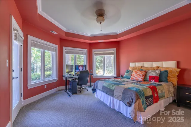 a bedroom with a bed and a large window