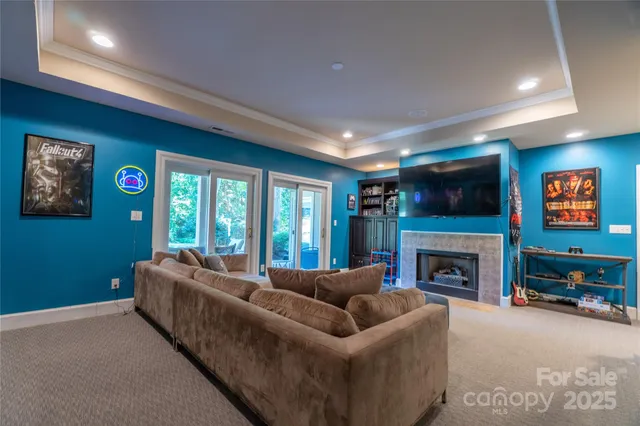 a living room with furniture a flat screen tv and a fireplace