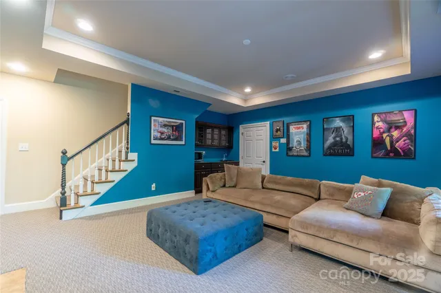 a living room with furniture and a stairs