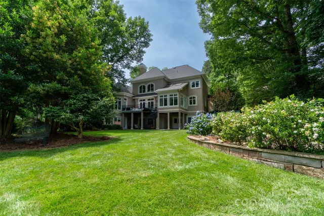a view of a house with a yard and sitting area