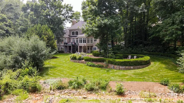 a view of a house with swimming pool and sitting area