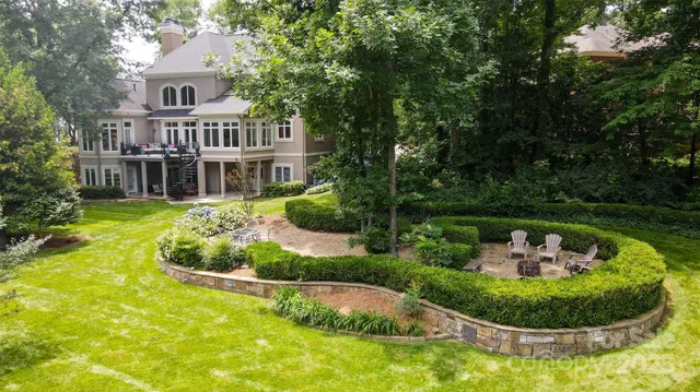 a swimming pool with outdoor seating and yard