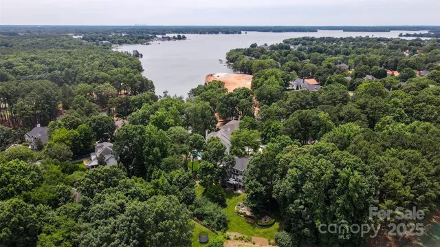 an aerial view of a houses with a lake view