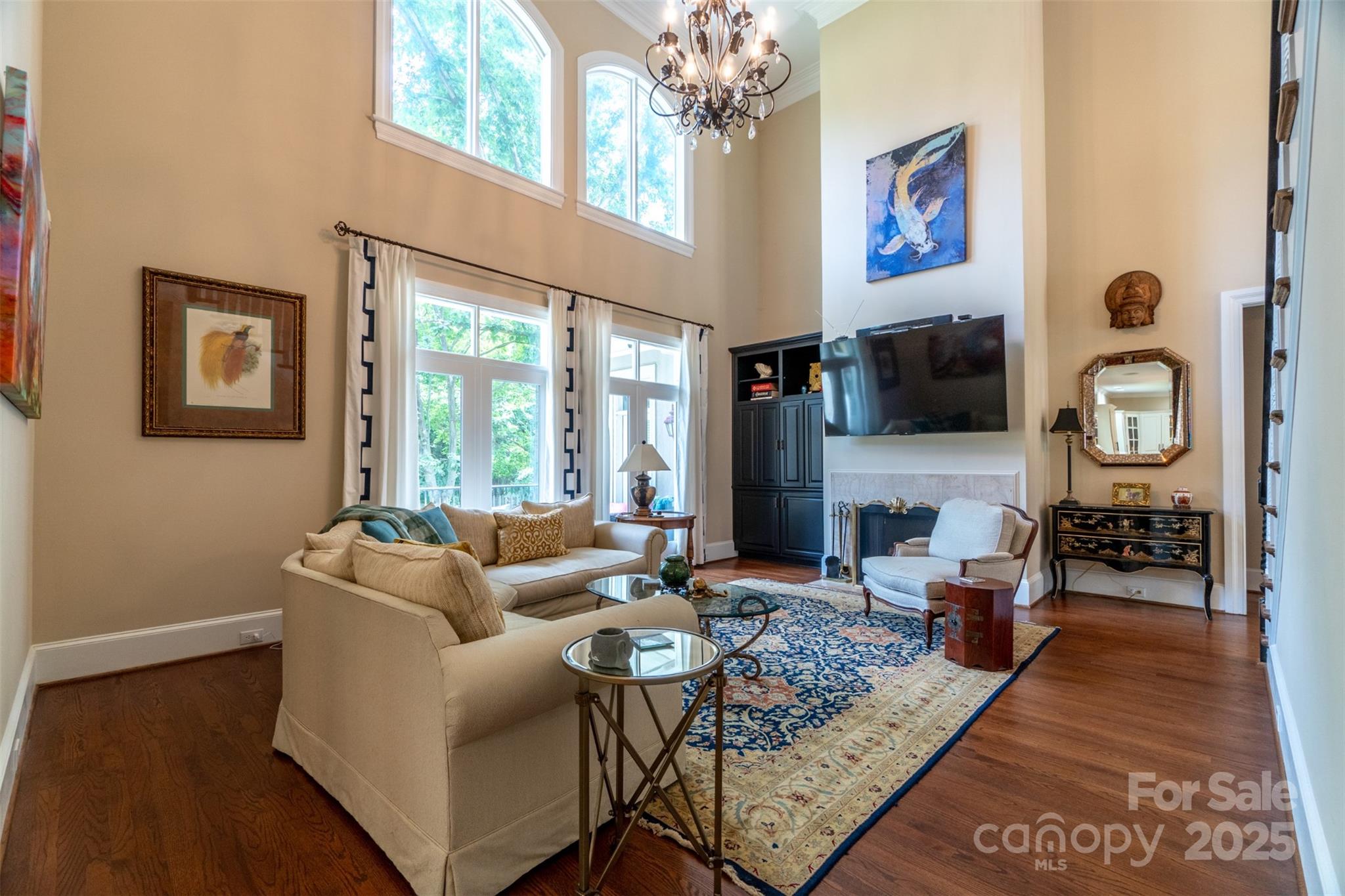 19002 Meta Road Cornelius, NC 28031 - Photo 5 of 48 a living room with fireplace furniture and a flat screen tv