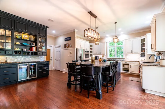 a large kitchen with a table and chairs