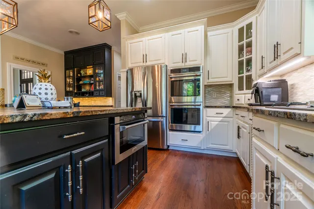 a kitchen with stainless steel appliances and wooden cabinets