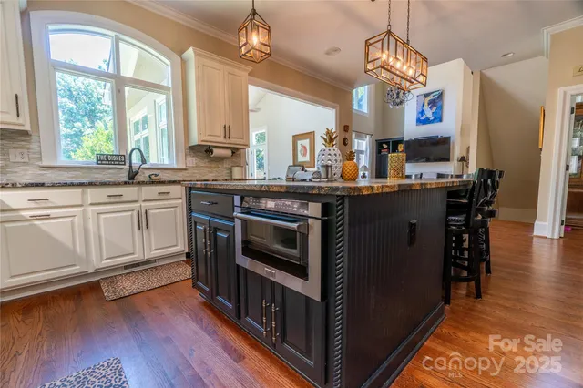 a kitchen with stainless steel appliances wooden floors and wooden cabinets
