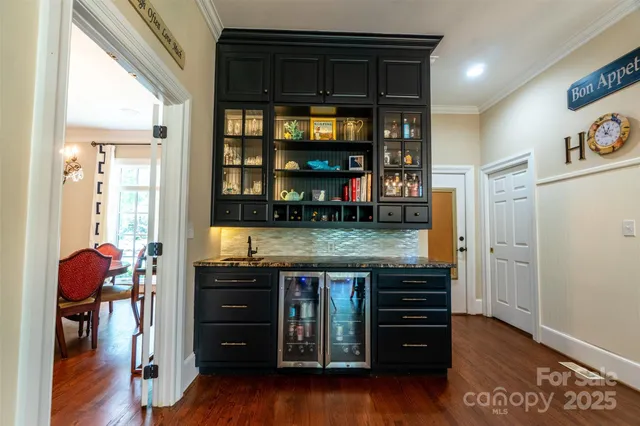 a kitchen with granite countertop a stove and a wooden cabinets