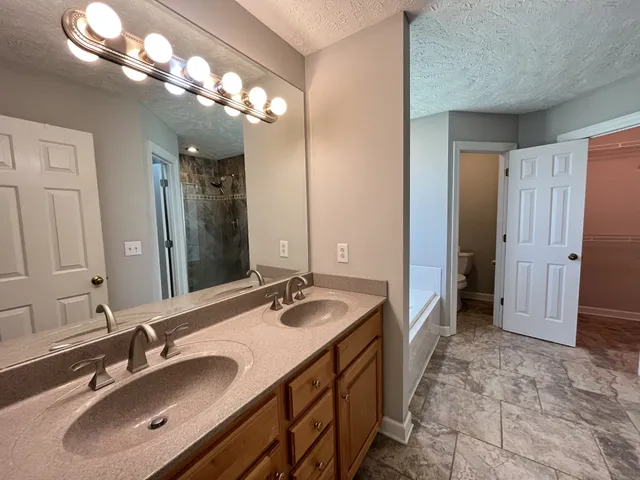 a spacious bathroom with a double vanity sink mirror and double