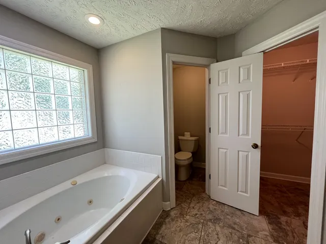 a bathroom with a tub shower and sink