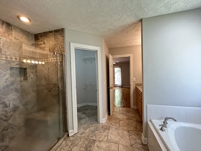 a bathroom with a bathtub and a shower
